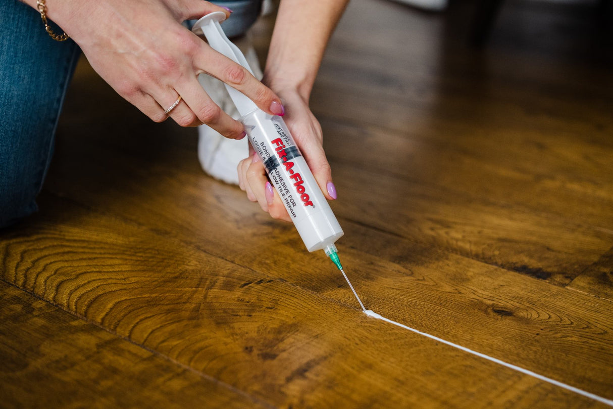 Repairing gaps in wooden flooring with Fix-A-floor and the precision syringe kit