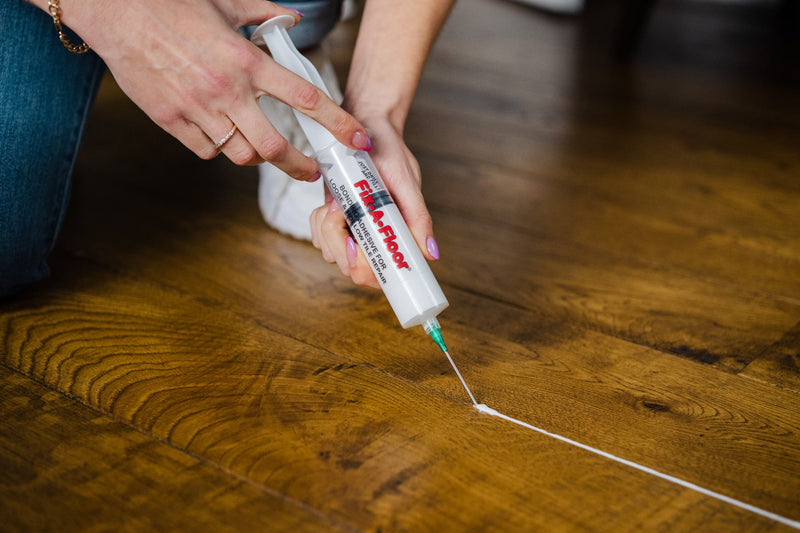 Load image into Gallery viewer, Repairing gaps in wooden flooring with Fix-A-floor and the precision syringe kit