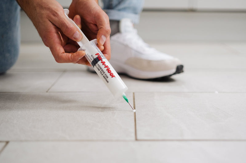 Load image into Gallery viewer, A man applying adhesives through 60ml Fix-A-Floor Syringe
