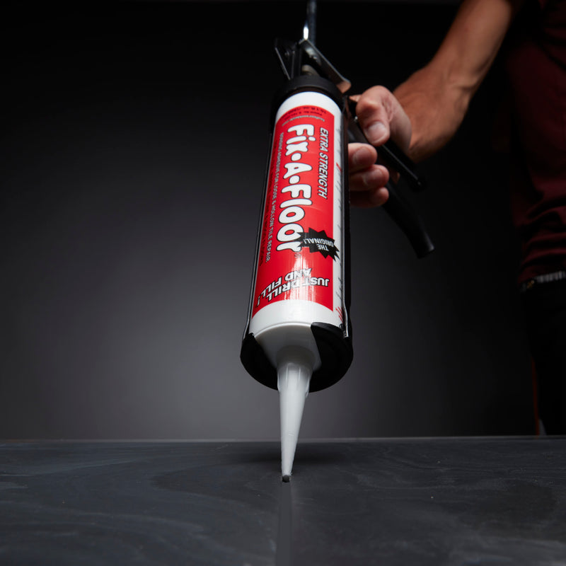 Load image into Gallery viewer, Dripless Caulk Gun with fix a floor adhesive fitted in
