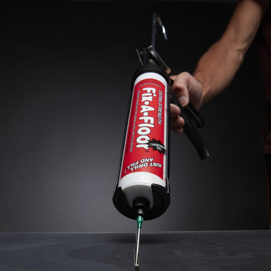 Dripless Caulk Gun with fix a floor adhesive fitted in