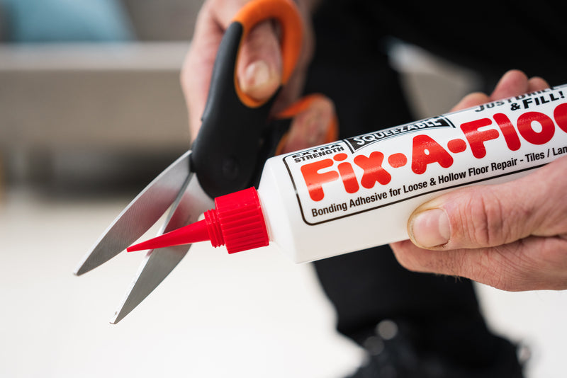 Load image into Gallery viewer, Box of 12 - Fix-A-Floor Squeezy All-In-One Repair Adhesive for Loose, Hollow and Creaky Tiles, Wood, LVT, LVP and Laminate Flooring
