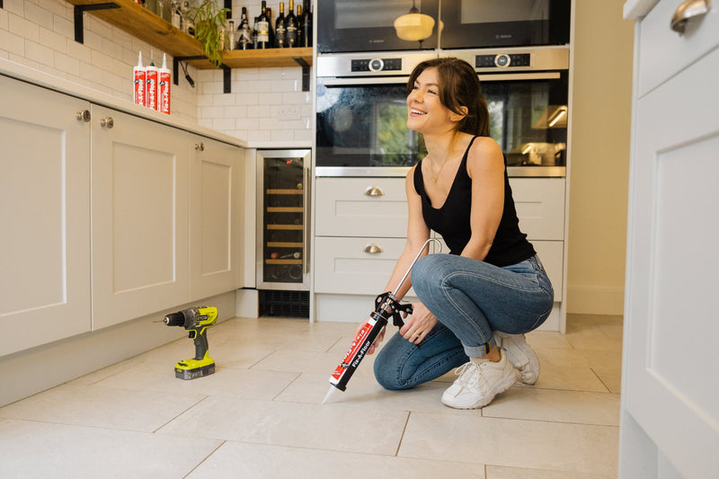 Load image into Gallery viewer, laughing Women holding a Tube with a caulk gun
