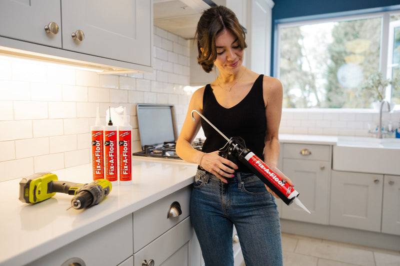 Load image into Gallery viewer, Women holding a Tube with a caulk gun
