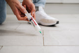 A man applying adhesives through 60ml Fix-A-Floor Syringe