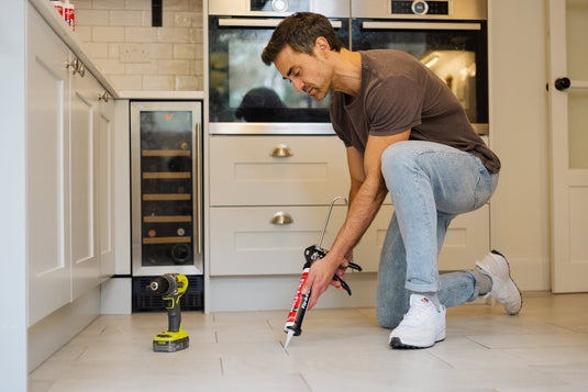 Men fixing a creaky floor with hollow Tile Tube