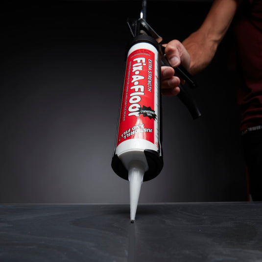 Dripless Caulk Gun with fix a floor adhesive fitted in